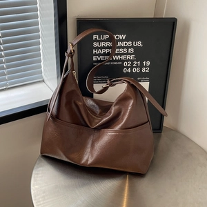 Large dark brown vintage tote bag in glossy leather with adjustable shoulder strap