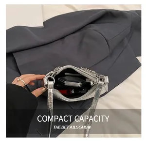 Top view of metallic silver crossbody bag interior showing daily items and storage capacity