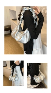 Detail of silver metallic cloud bag featuring a unique pleated scrunchie handle design