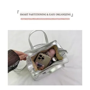 Internal view of silver metallic handbag showing large capacity for phone and umbrella