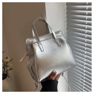 Silver metallic bag detail with pleated texture and FASHION & BAGS logo print