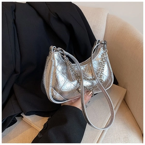 Close-up of silver quilted hobo bag with metallic finish and dual chain shoulder straps
