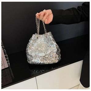 Detail of silver sequin bucket bag with shiny metallic chain for evening parties