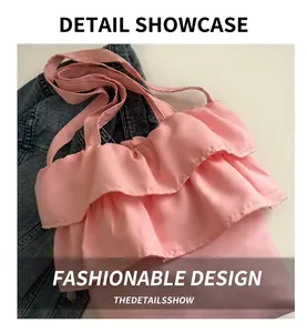 Close-up of pink ruffled canvas tote bag showing soft fabric pleats on denim background