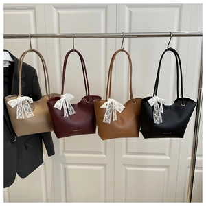 Detail showing four stylish tote bags in khaki, burgundy, tan, and black with lace bows