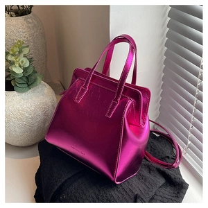 Close-up of fuchsia metallic leather handbag featuring Fashion & Bag text detail