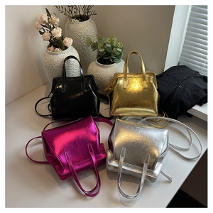 Detailed view of four metallic mini crossbody bags in black gold pink and silver