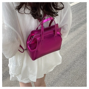 Close-up of metallic purple mini tote bag with glossy finish and double handles