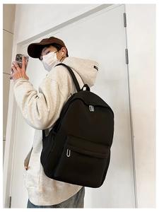 Side view of a large black nylon student backpack showing its spacious capacity and straps