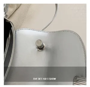 Detailed macro view of silver metallic saddle bag with polished rotating metal lock