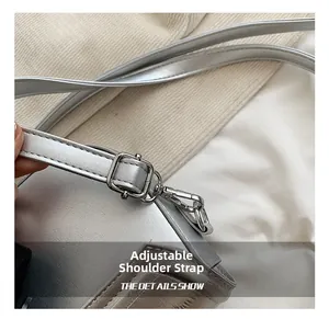 Close-up of the adjustable silver leather shoulder strap with metallic buckle detail