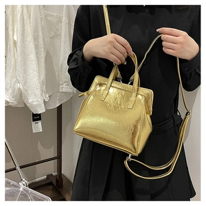 Detail of a vintage golden metallic handbag with pleated texture and stylish clasp