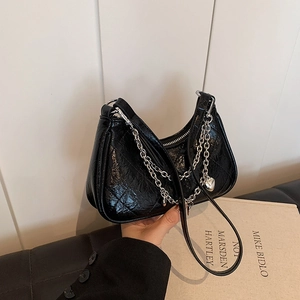 Black wrinkled faux leather baguette bag with silver chain and heart charm