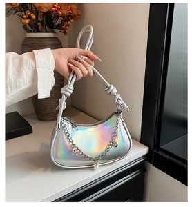 Detail of silver crescent bag with pearlescent finish and decorative metallic star charms