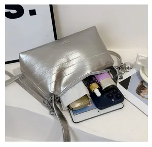 Silver metallic textured bucket bag with interior view showing high storage capacity