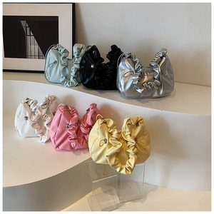 Detailed display of pleated handbags in six vibrant colors on modern display props