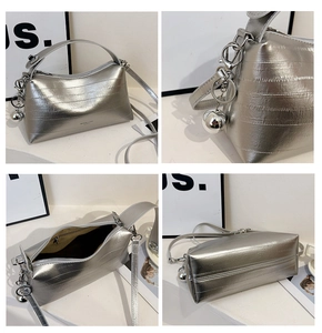 Detail shots of textured silver bucket bag with metallic ball charm and zipper closure
