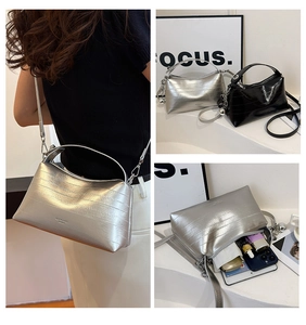Detail of silver textured crossbody bag showing internal capacity for phone and makeup