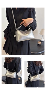 Close-up of silver textured bucket bag with crocodile pattern and metallic ball charm