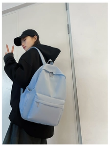 Detailed side view of light blue nylon backpack with side water bottle pocket