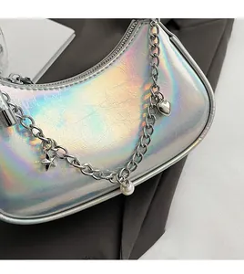Macro detail of holographic silver moon bag with decorative heart and star metal chain