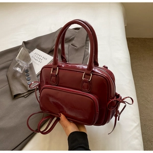 Minimalist burgundy PU leather Boston handbag with shiny finish and double top handles