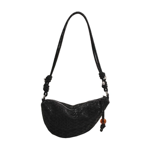 Minimalist black half-moon crossbody bag with scale texture and beaded zip detail
