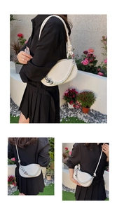 Three-way view of white semi-circular bag with large pearls and heart-shaped chain
