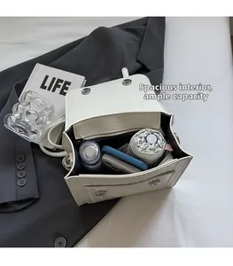 Interior view of white crocodile pattern bag showing capacity for phone and umbrella
