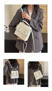 Detail of white vintage PU leather backpack with silver buckles and multi-functional straps
