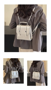 Detail of silver metallic textured mini backpack with flip cover and metal handle
