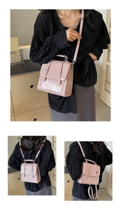 Detailed views of pink crocodile pattern backpack with adjustable silver hardware straps