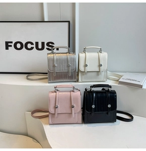 Chic textured mini handbags in silver, pink, and black colors displayed on steps