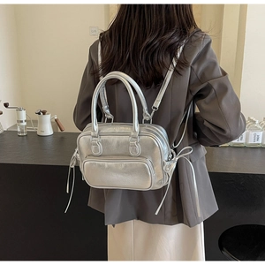 Detail of silver metallic backpack and handbag with double handles and drawstrings