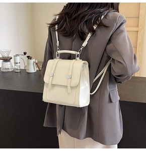 Detailed back view of a minimalist cream PU leather backpack with adjustable straps