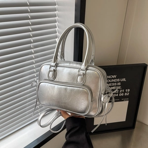 Silver retro textured Boston backpack with double handles and bow detail in natural light