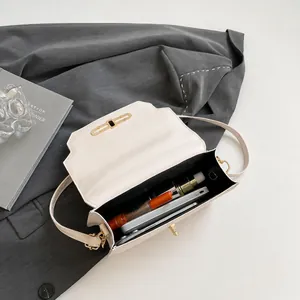 Interior view of the cream crossbody bag showing capacity for phone and lipstick