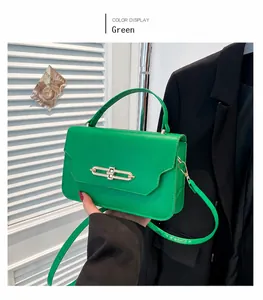 Close-up of vibrant green PU leather crossbody bag with elegant gold metal clasp