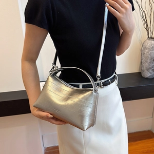 Silver textured bucket bag with metallic eel pattern, top handle and crossbody strap