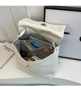 Detailed view of the spacious inner compartments of the cream leather backpack for storage