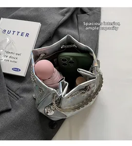 Internal view of silver bucket bag showing capacity for phone and small umbrella