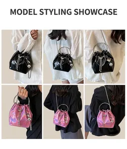Detailed views of crossbody bucket bags with ring handles and metal chain straps on model
