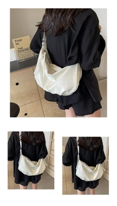 Close-up of white oversized soft leather hobo bag showing crinkled texture and wide strap