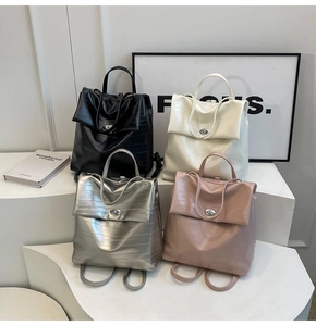 Multiple colors of textured laptop backpacks with metallic twist lock and top handles
