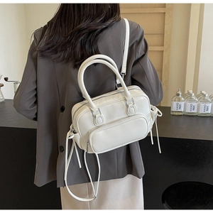 White PU leather backpack for women with side drawstrings shown on a model's back