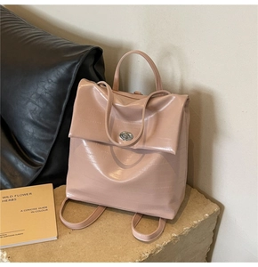 Detail view of pink leather backpack with elegant silver turn-lock and slim straps