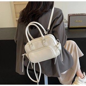 White PU leather minimalist backpack shown in daily use with stylish commuting outfit