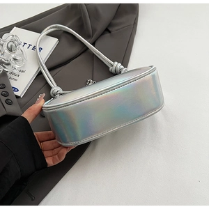 Detail of silver holographic dumpling bag with knotted handle and pleated texture