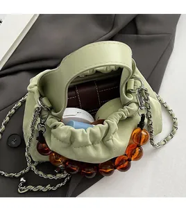 Detail view of mint green PU bag interior showing spacious capacity for wallet and cosmetics