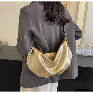 Metallic bronze hobo bag with horizontal textured stripes and wide shoulder strap